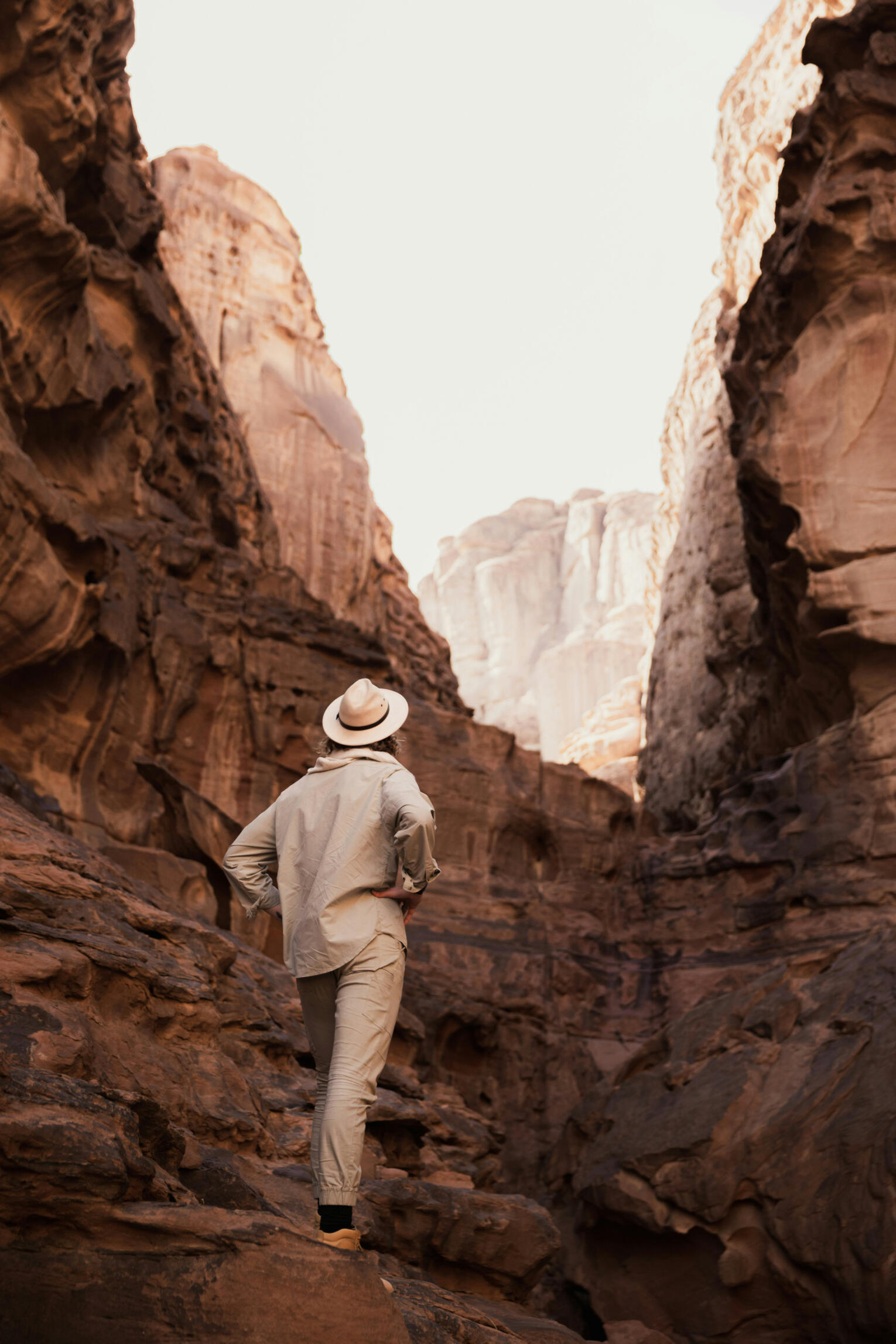 alt="an image showing a man walking through a canyon"